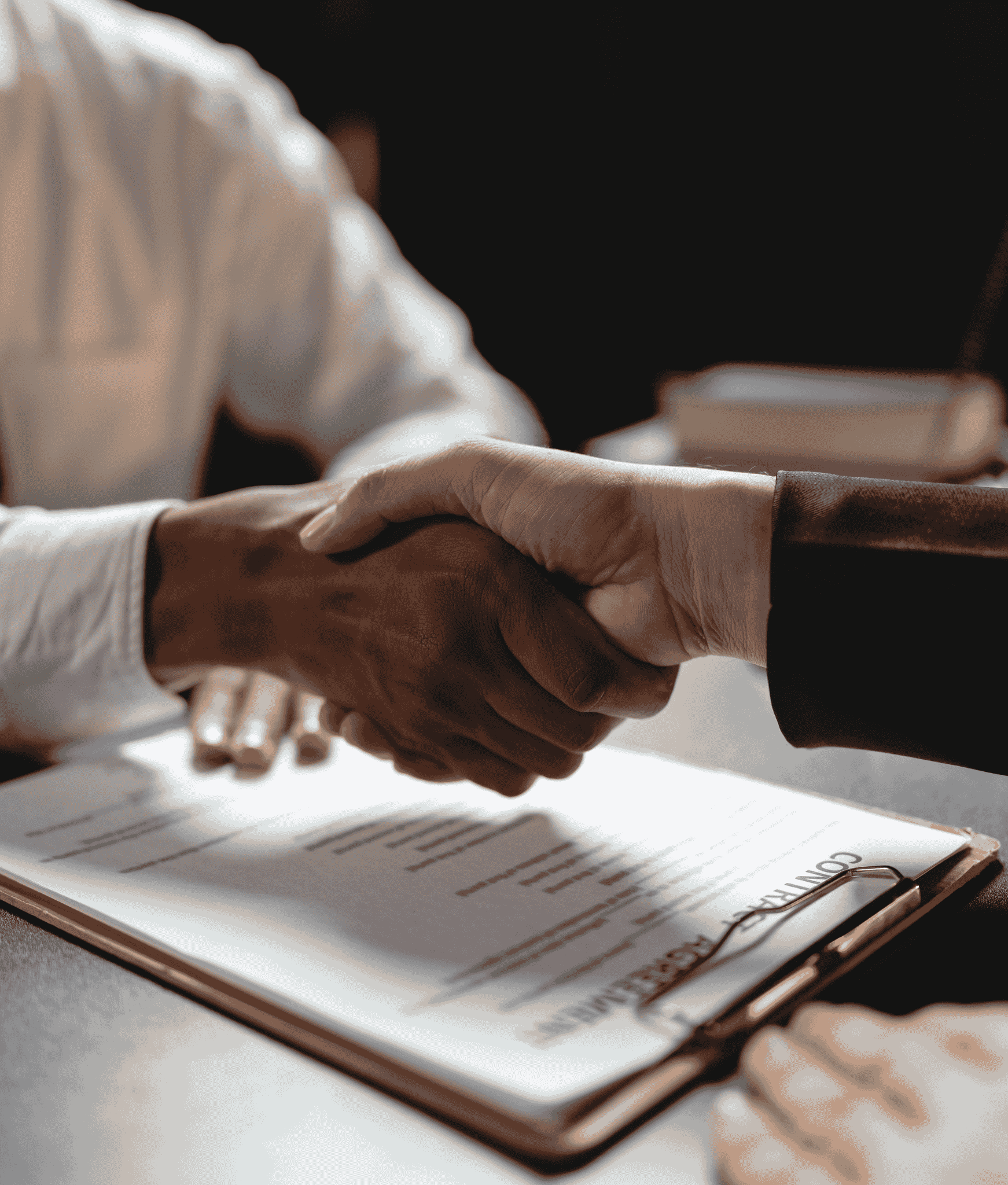Employer and employee shaking hands after agreement made.