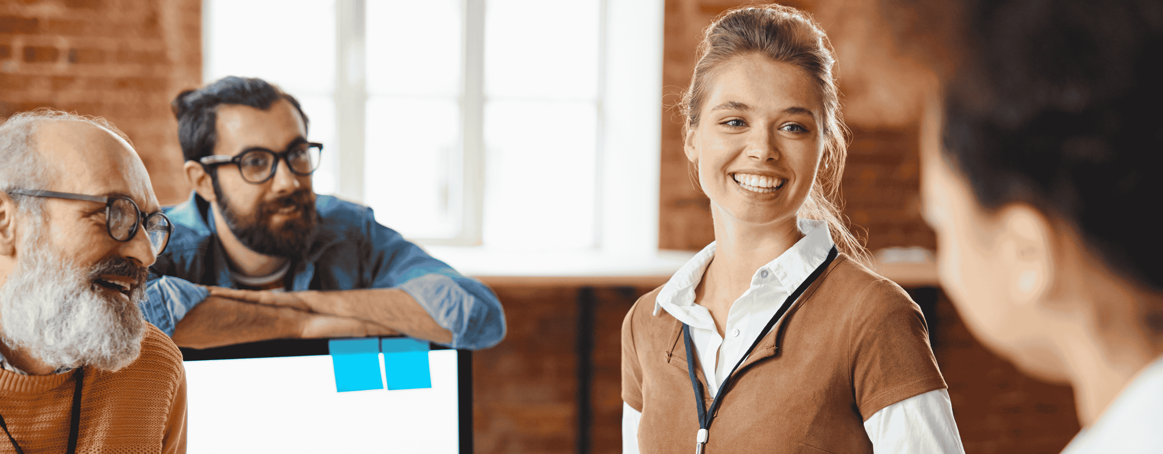Young female employee happy and smiling joking with colleagues
